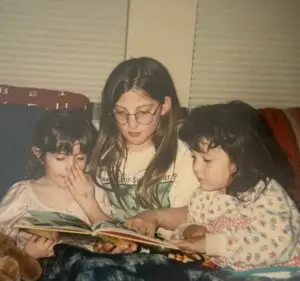 Rachel (in the center) at age 10 reading to family friends.